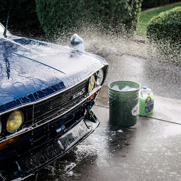 Blue Datsun car being washed. Turtle Wax car wash liquid visible. Car detailing India.