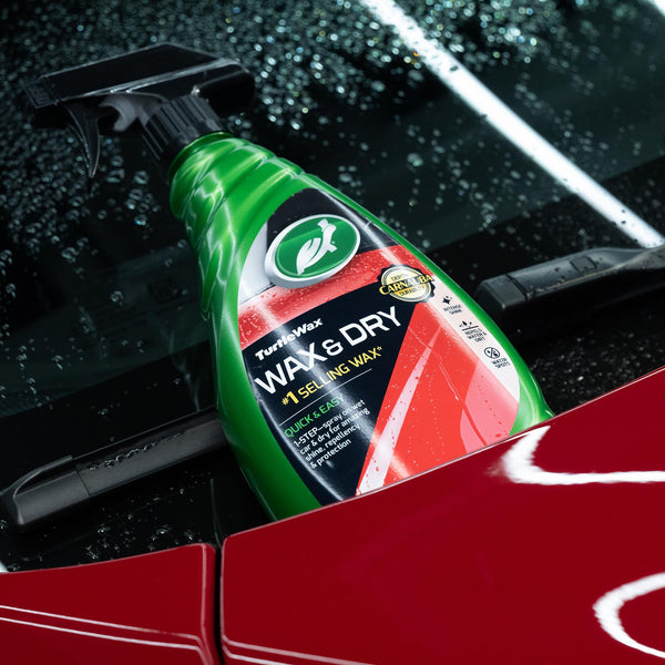 Car detailing spray. Green Turtle Wax bottle on a red car's surface. Instant shine & water repellent.