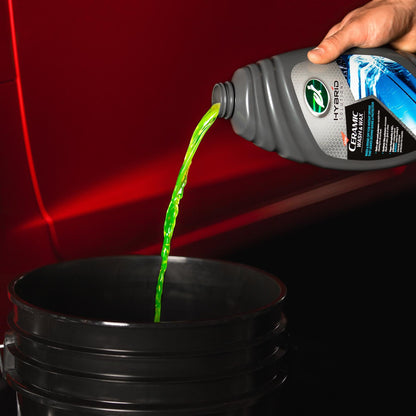 Turtle Wax Hybrid Solutions: Ceramic car wash liquid being poured. Car care, detailing product.