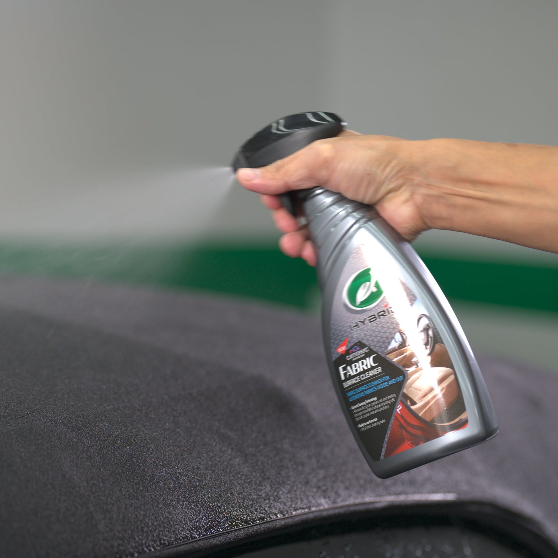 Turtle Wax Hybrid Solutions fabric cleaner being sprayed. Car care cleaning product for India.