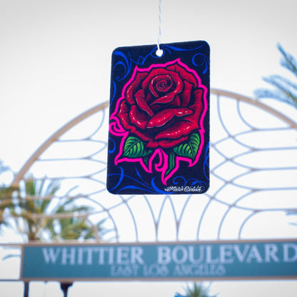 Automotive paper freshener with rose design, hanging on Whittier Boulevard, Los Angeles. Car accessories India.