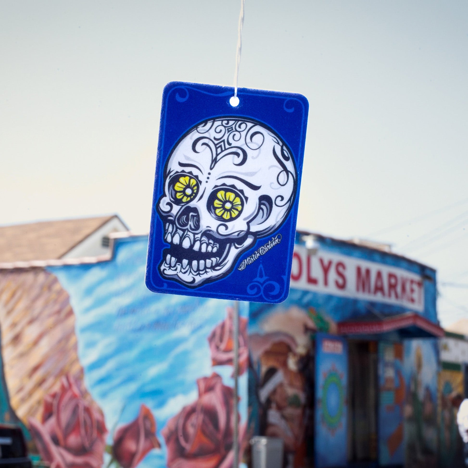 Blue air freshener with a skull art. Indian auto accessories and car fragrance item.