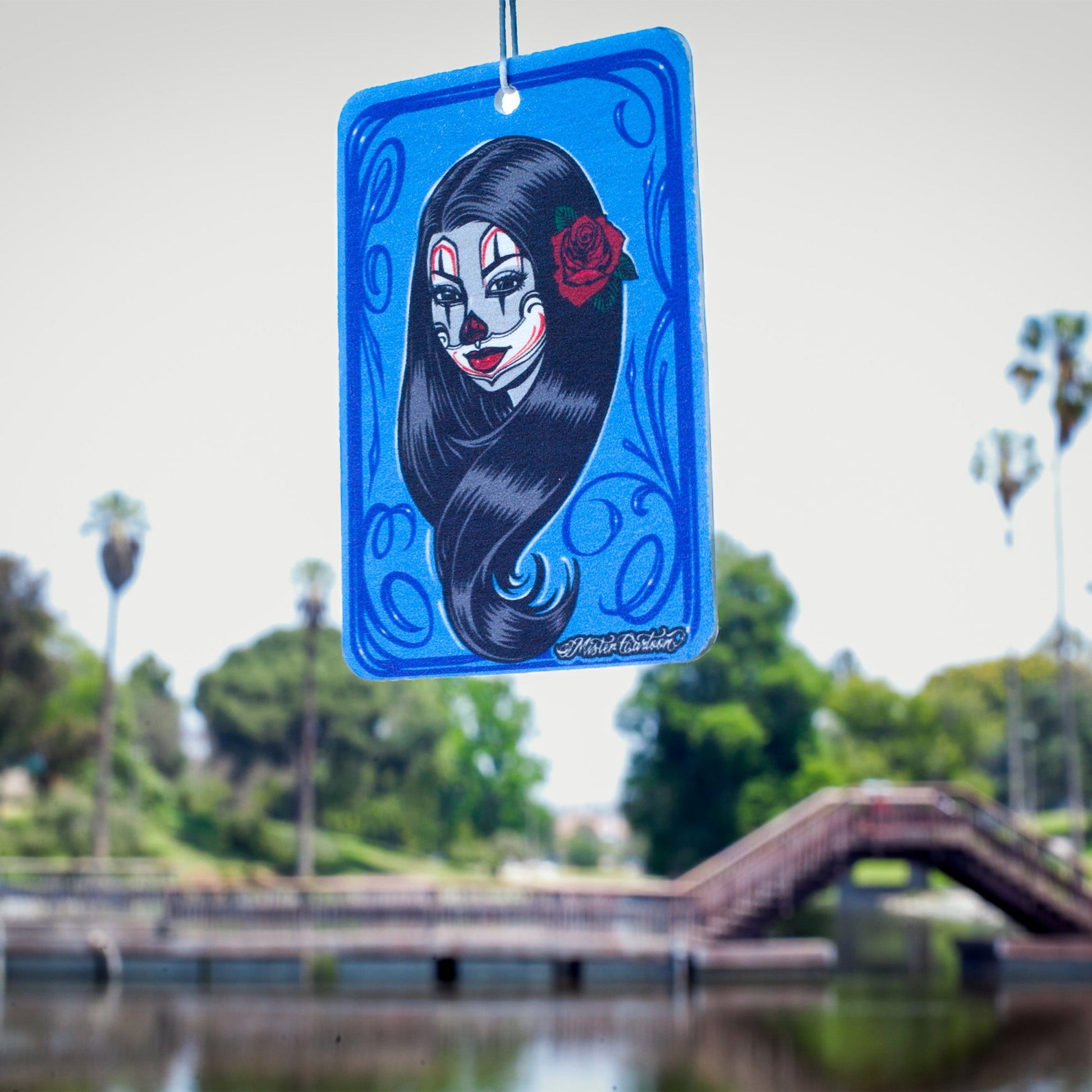 Hanging air freshener with Chola face art. नीले रंग का कलात्मक चित्र.
