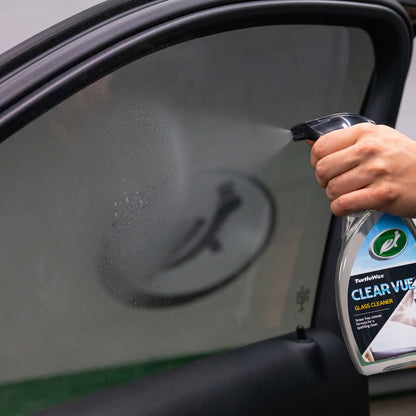 Turtle Wax Clear Vue Glass Cleaner spray being applied to a car window. For clean, smear-free visibility on Indian roads.