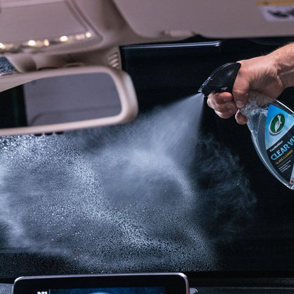 Turtle Wax ClearVue being sprayed on a car windshield. Auto glass cleaner for spotless visibility.