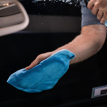 Cleaning car window. Car care product by Clearvue for Indian roads.