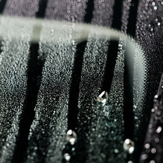 Raindrops bead on treated glass, enhancing visibility in Indian monsoons. Turtle Wax protection for safe driving.