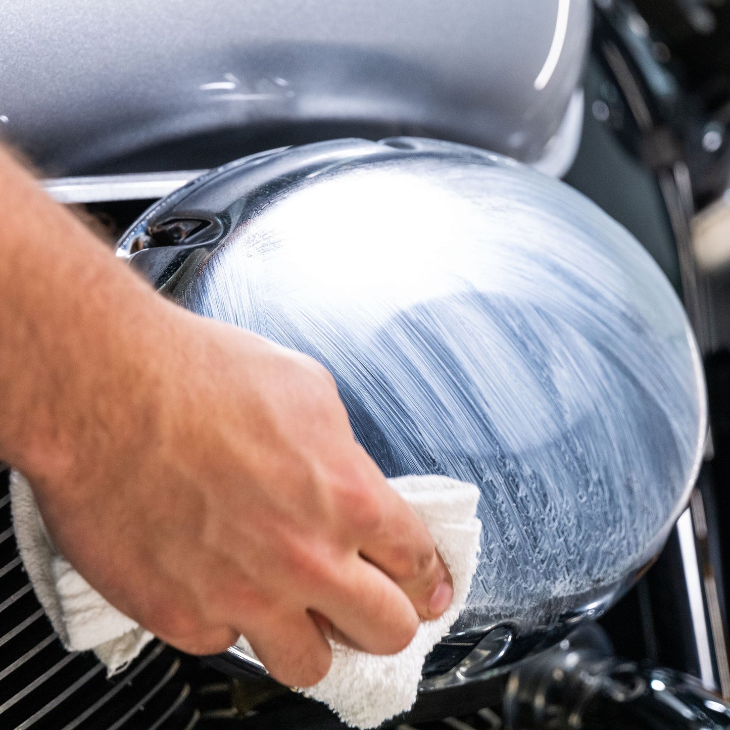 Polishing a motorcycle part. Buffing chrome finish. Turtle Wax for shine. Auto detailing.
