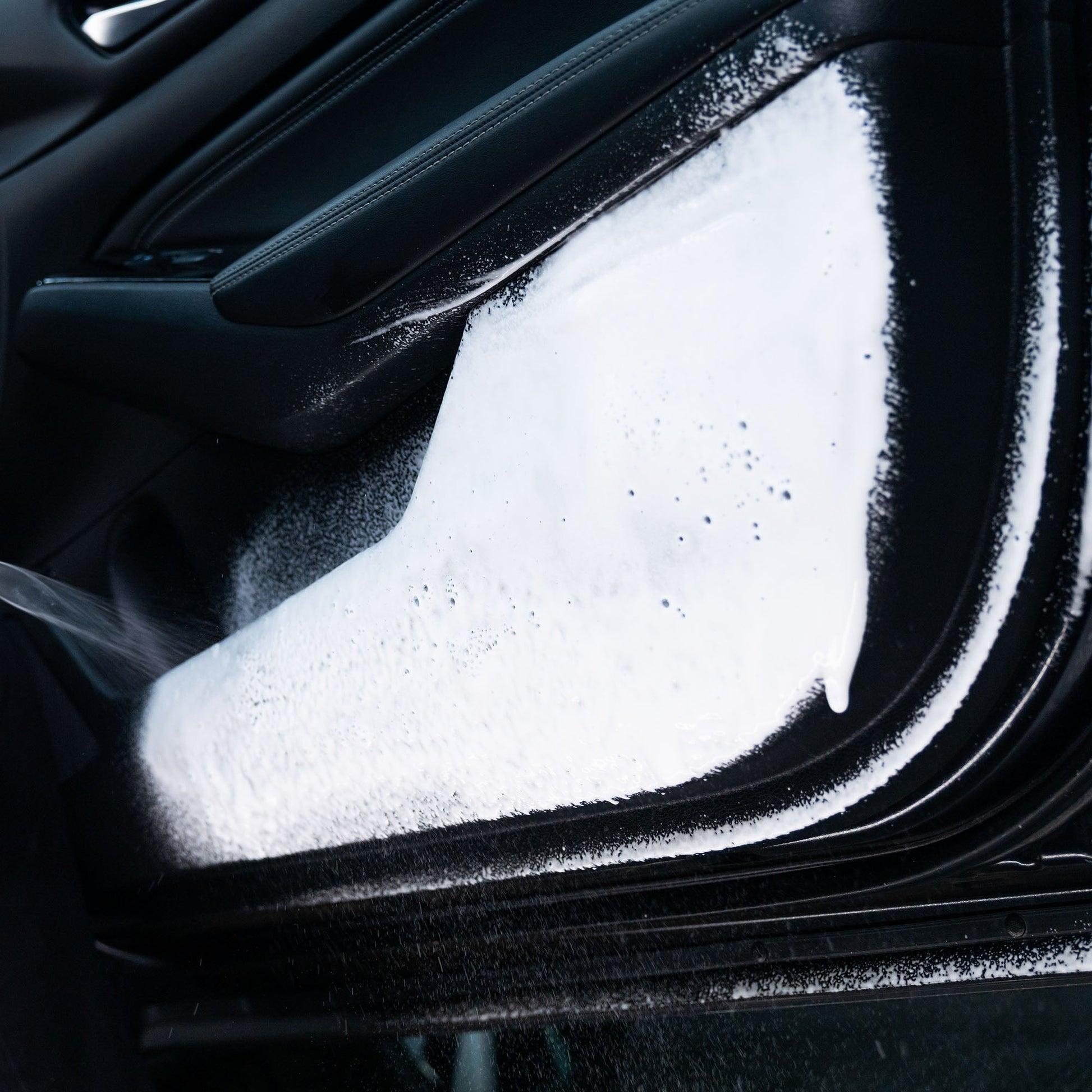 Car interior cleaning: Door panel with foam. Auto detailing service for vehicles in India.