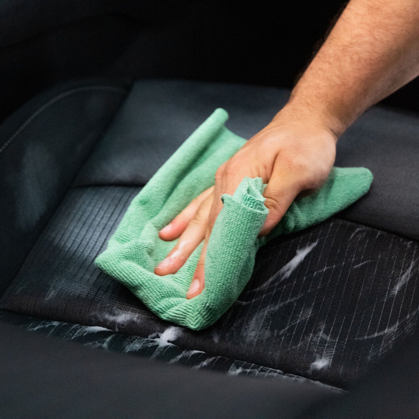 Cleaning car interior with a microfiber cloth. Auto detailing, India.
