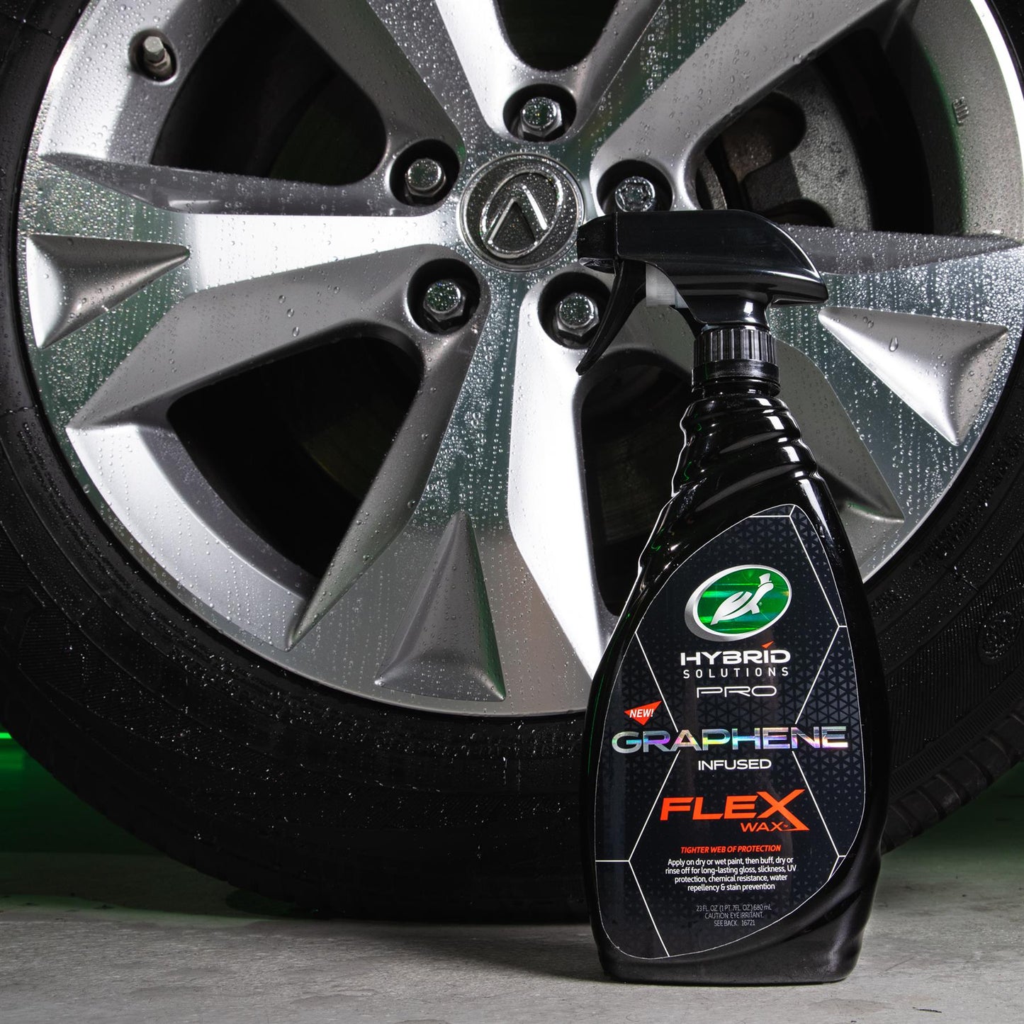Turtle Wax Hybrid Solutions Pro Graphene Flex Wax, a car care product, is pictured with a clean, shiny alloy wheel.