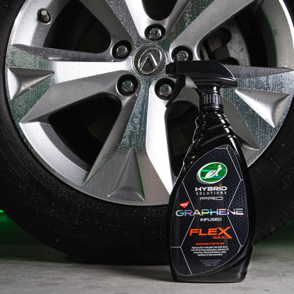 Turtle Wax Hybrid Solutions Pro Graphene Flex Wax, a car care product, is pictured with a clean, shiny alloy wheel.