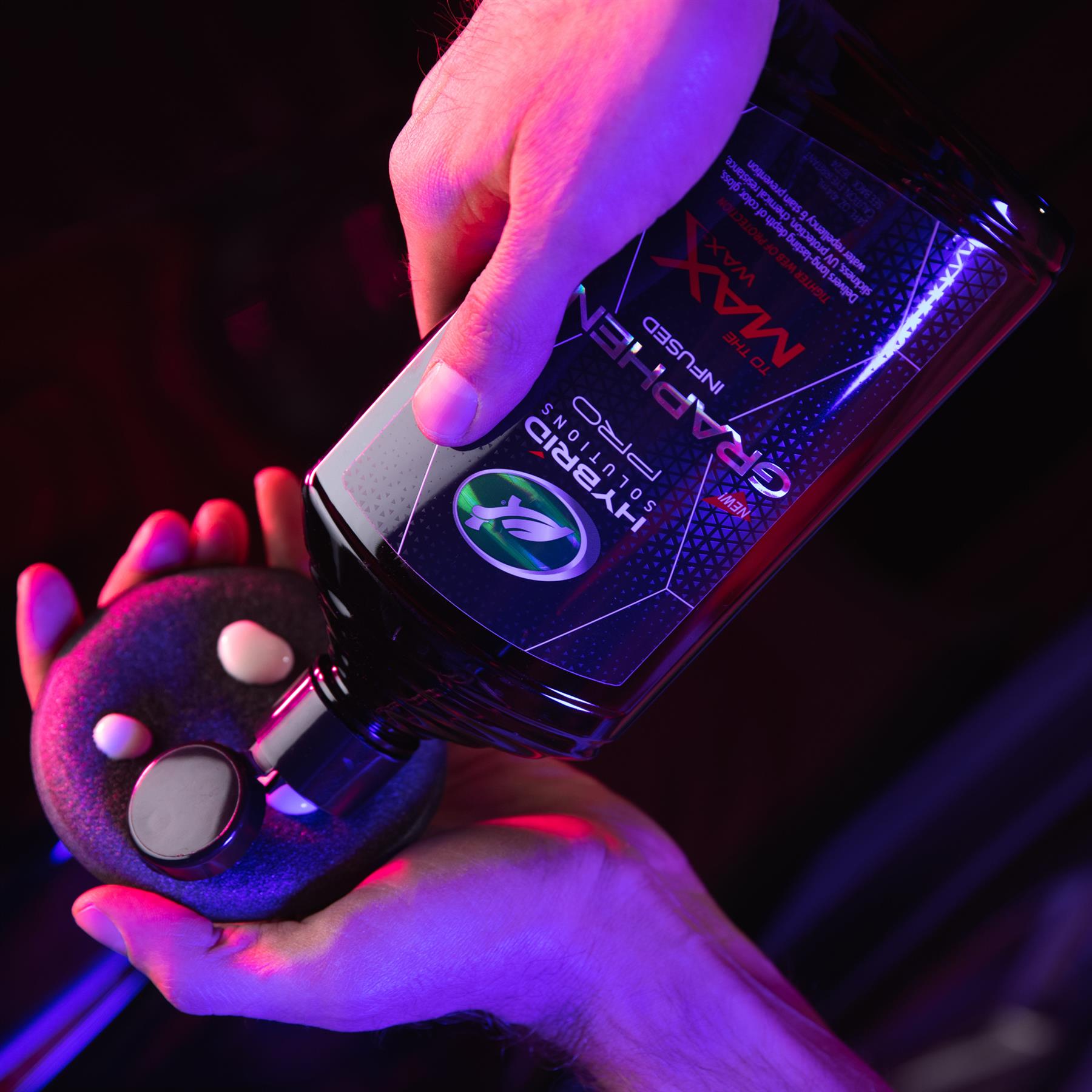 Turtle Wax Hybrid Solutions Graphene Max Wax being poured onto an applicator. Car care product for vehicle detailing.