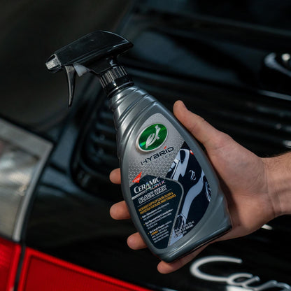 Hand holding Turtle Wax Hybrid Solutions Ceramic Acrylic Black Wax spray for black cars in India. Car care.