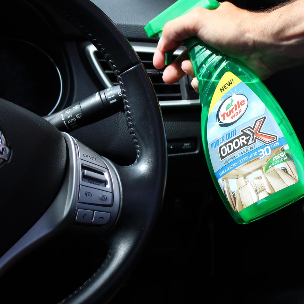 Interior shot of car being sprayed with Turtle Wax ODOR-X Odor Eliminator. Car freshener for a clean, new car scent in India.